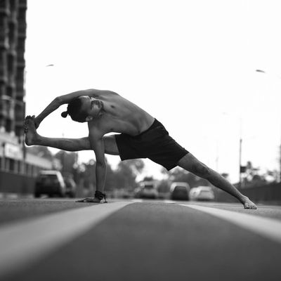 Athlete holding a stable balance pose in a minimalist space.