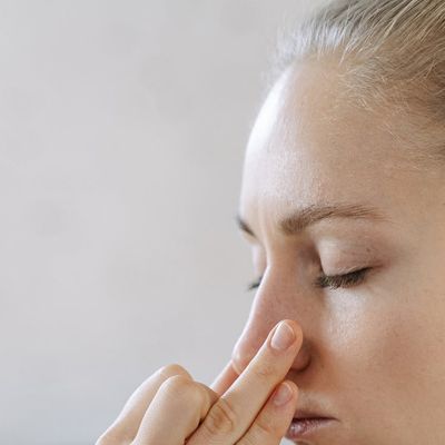 Side profile of a person practicing controlled breathing exercises.